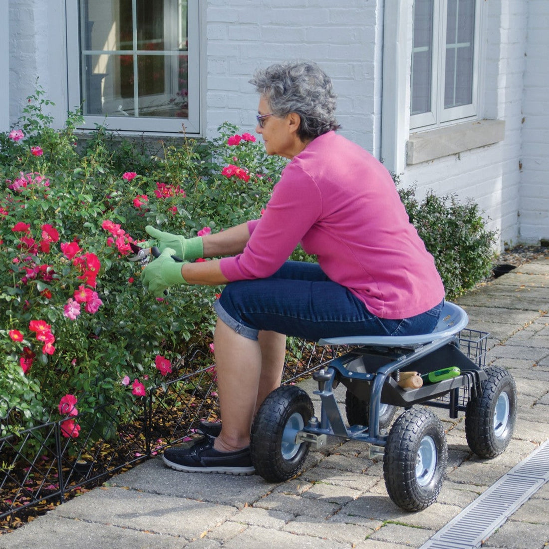 Scoot-N-Steer in use by woman pruning rose bushes