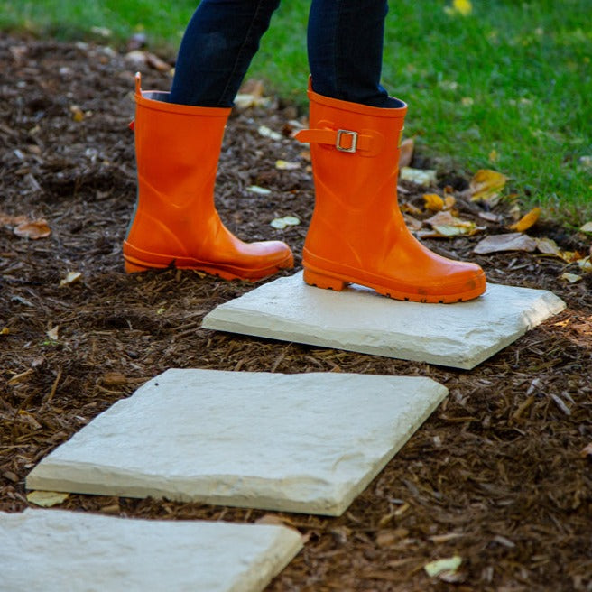 Square resin stepping stone being walked on to show durability